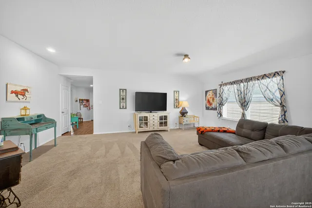 a kitchen with stainless steel appliances a refrigerator sink and wooden cabinets