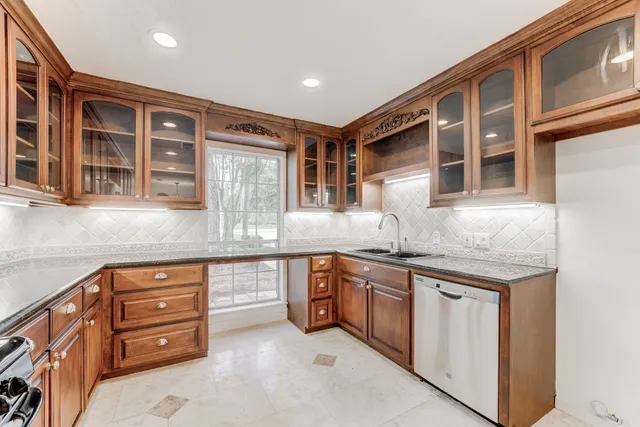 a kitchen with stainless steel appliances granite countertop a stove and cabinets