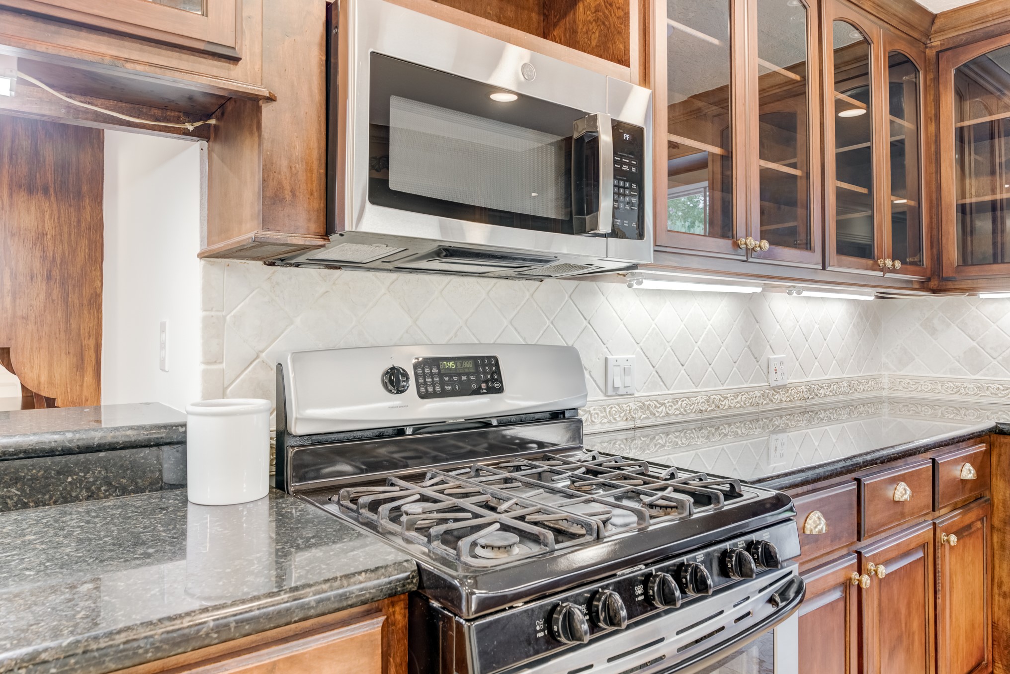 323 Spring Woods Drive Spring, TX 77386 - Photo 20 of 50 a stove top oven sitting inside of a kitchen