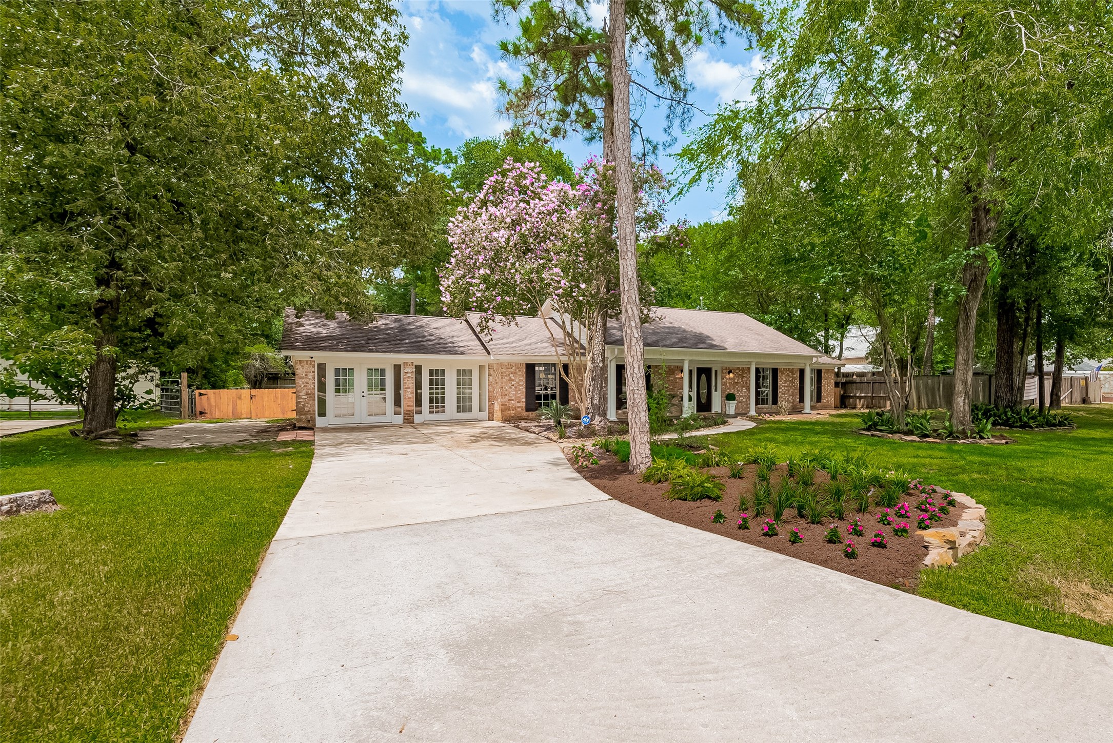 323 Spring Woods Drive Spring, TX 77386 - Photo 2 of 50 a front view of a house with a garden