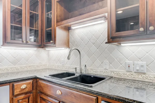 a kitchen with a sink and cabinets