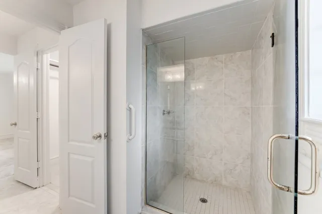 a bathroom with a glass shower door