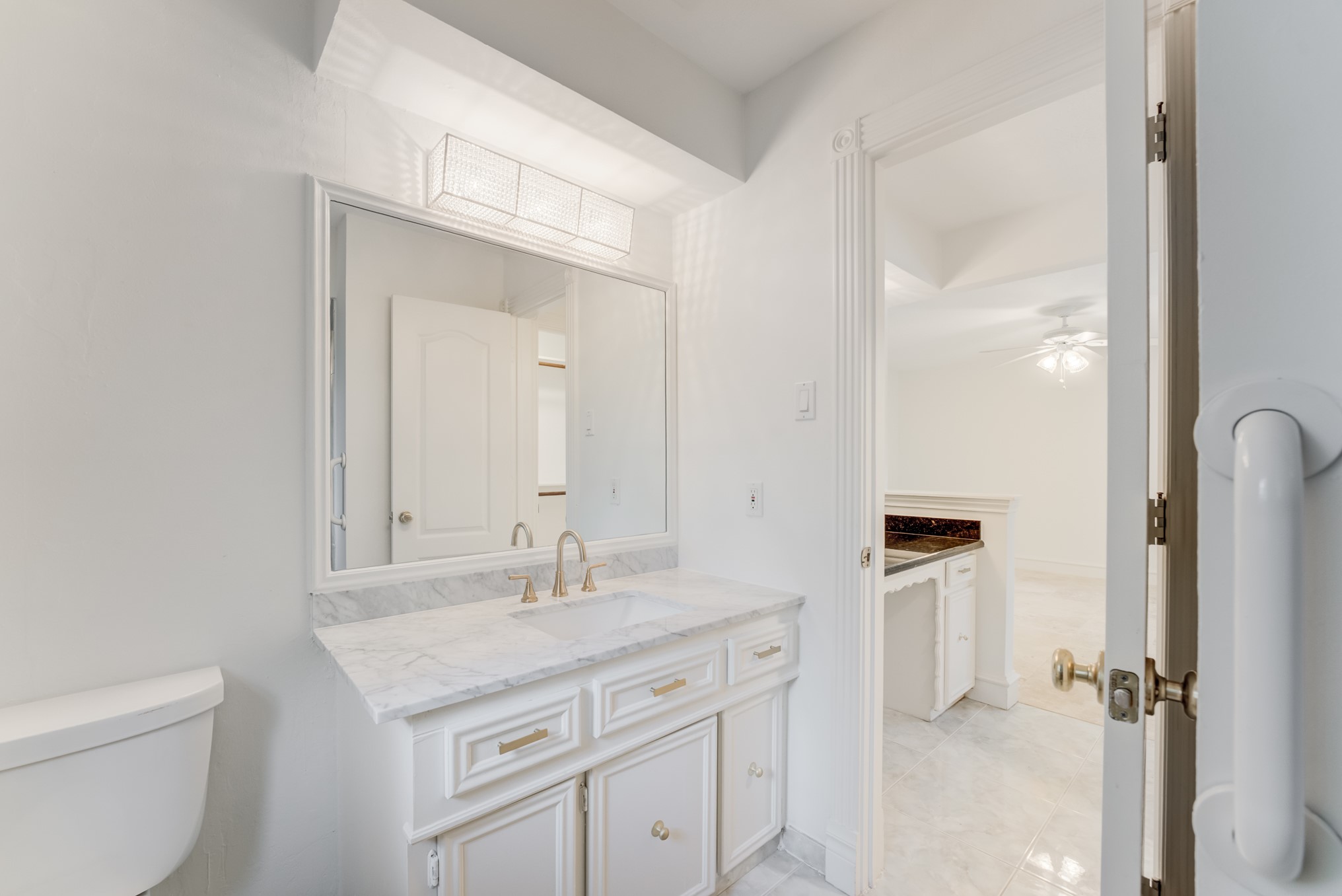 323 Spring Woods Drive Spring, TX 77386 - Photo 30 of 50 a bathroom with a granite countertop sink a toilet and a mirror