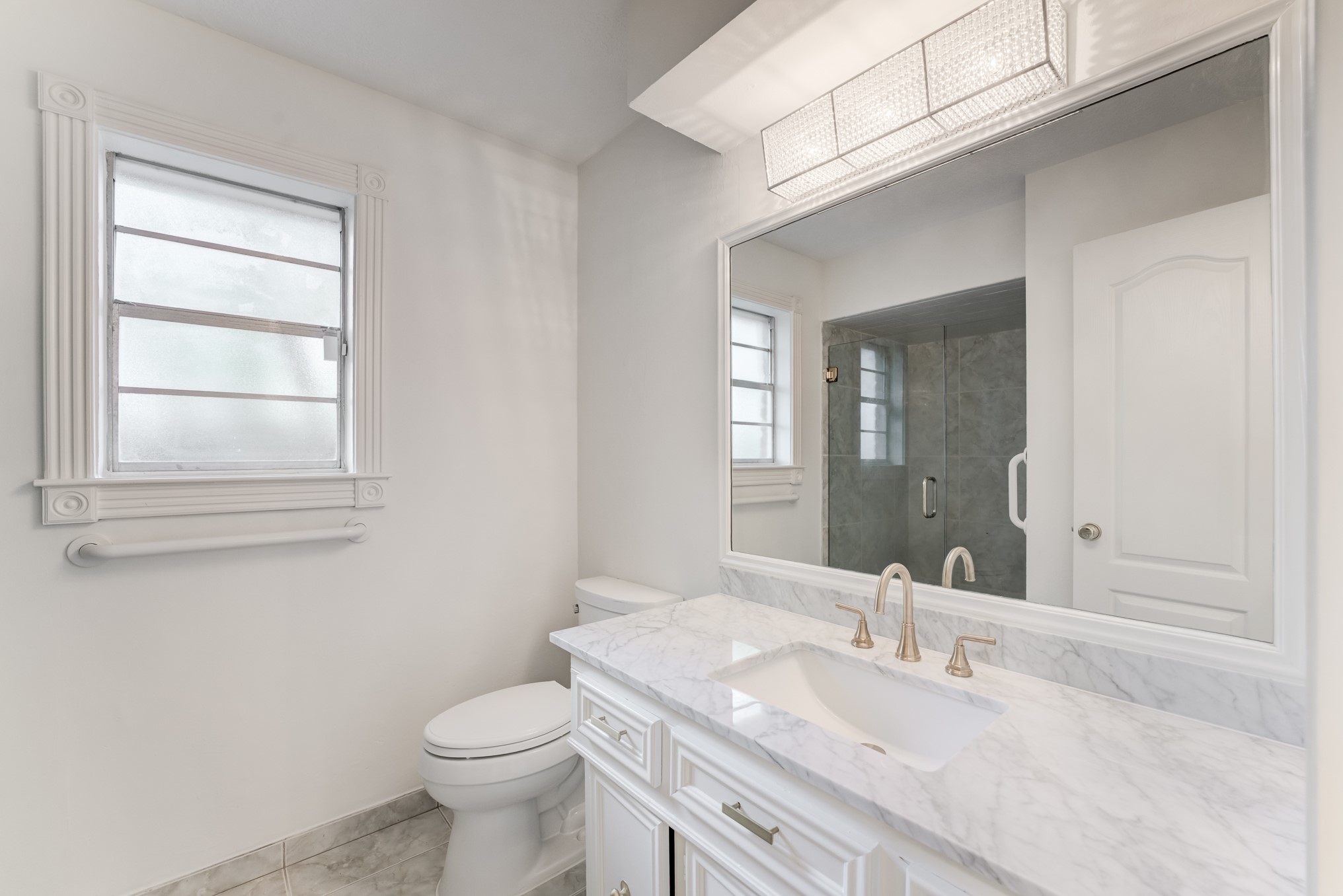 323 Spring Woods Drive Spring, TX 77386 - Photo 33 of 50 a bathroom with a granite countertop toilet a sink and mirror