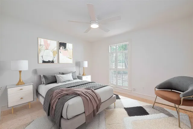 a bedroom with a bed a couch and window