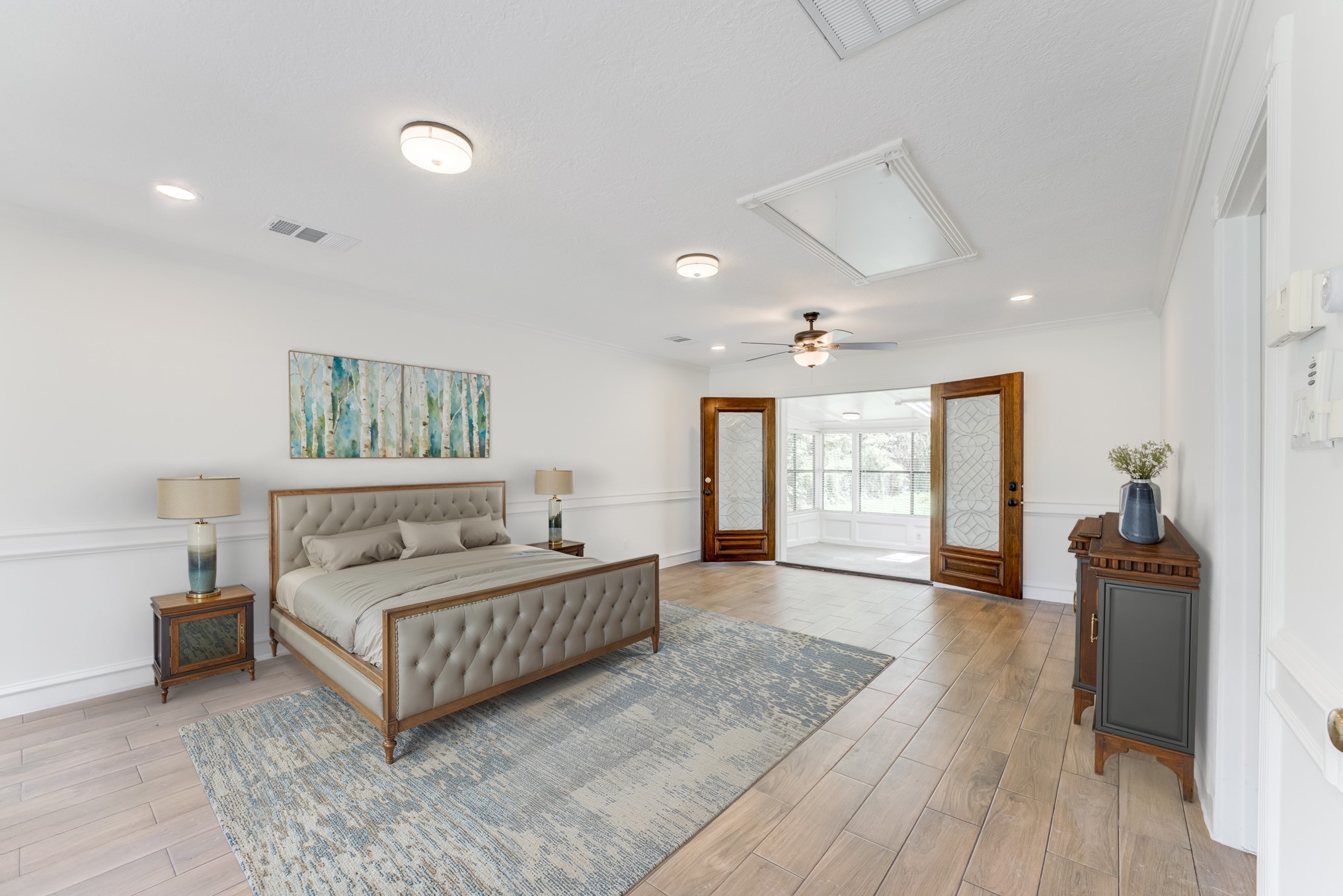 323 Spring Woods Drive Spring, TX 77386 - Photo 43 of 50 a spacious bedroom with a large bed and a wooden floor