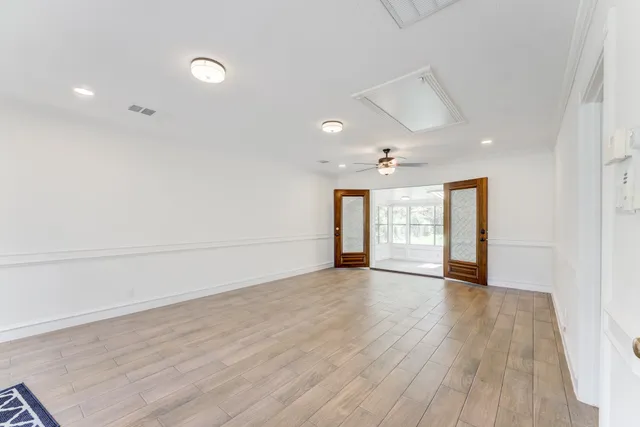 a view of a swimming pool with a table and chairs under an umbrella