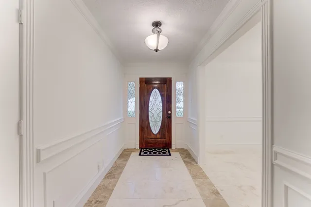a view of a hallway with a dining room