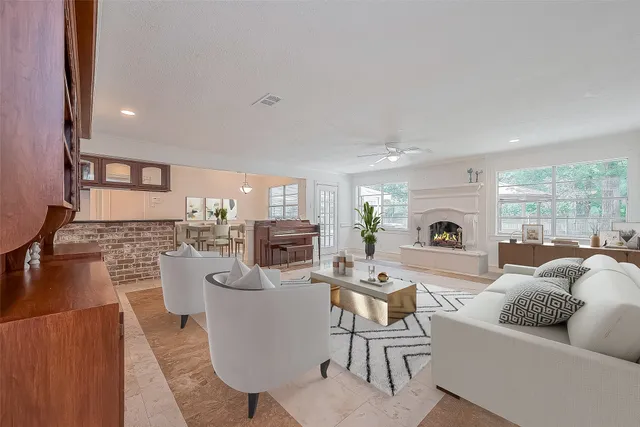 a living room with fireplace furniture and a fireplace