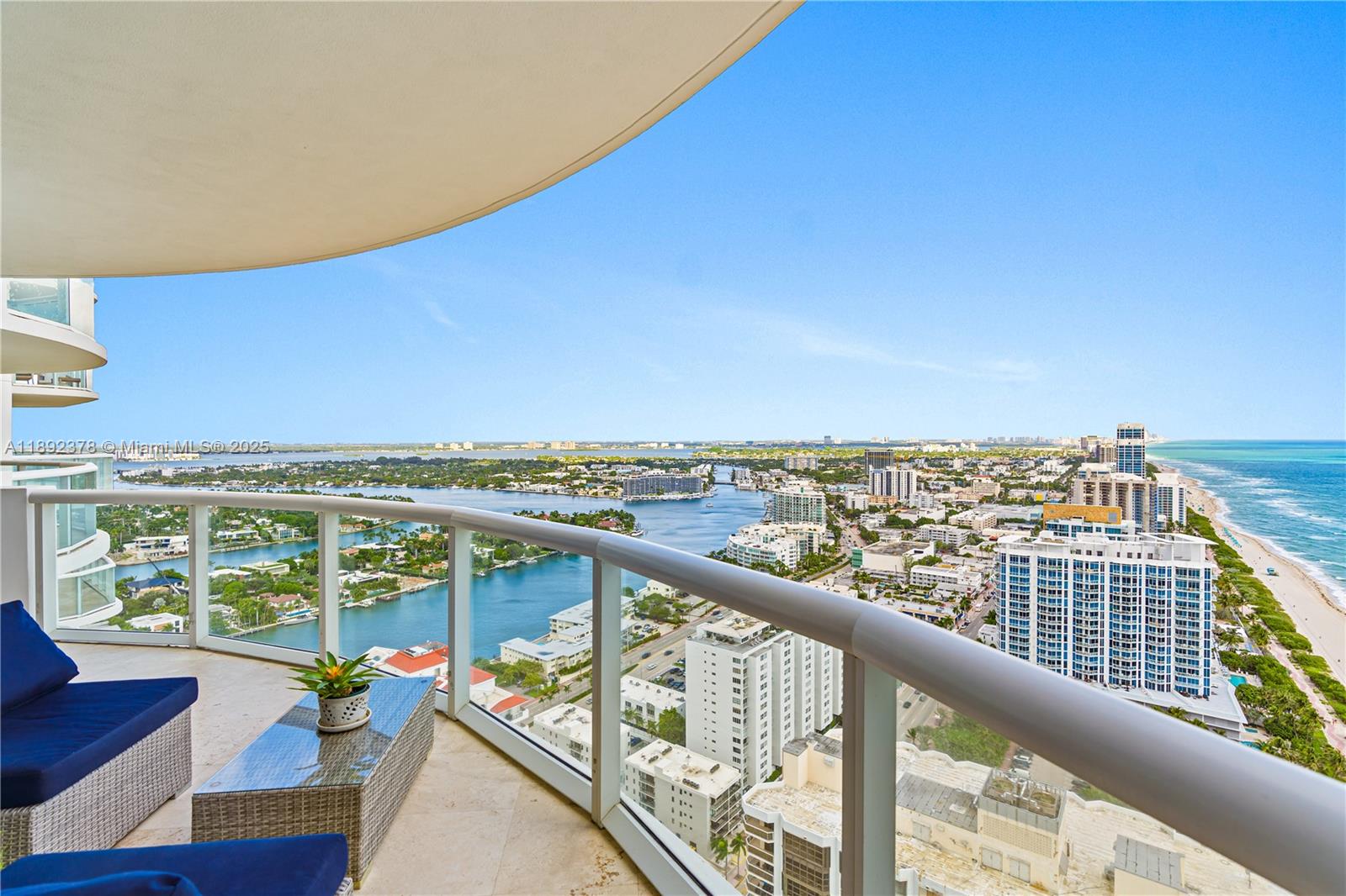 6365 Collins Avenue, Unit 3611 Miami Beach, FL 33141 - Photo 1 of 20 a view of a balcony with wooden floor and seating space