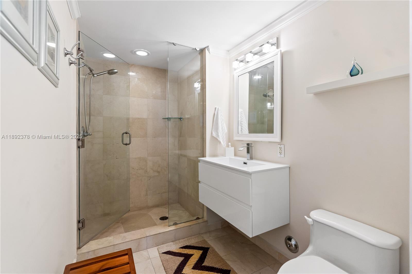 6365 Collins Avenue, Unit 3611 Miami Beach, FL 33141 - Photo 11 of 20 a bathroom with a sink a toilet and shower