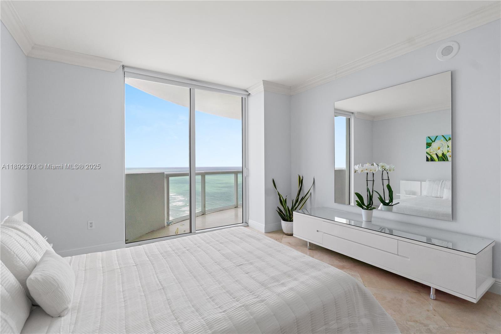 6365 Collins Avenue, Unit 3611 Miami Beach, FL 33141 - Photo 12 of 20 a bedroom with a large bed and a potted plant