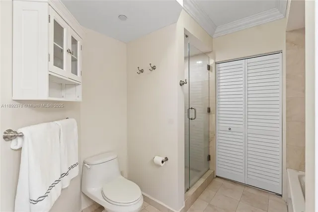 a white toilet sitting next to a bathroom sink