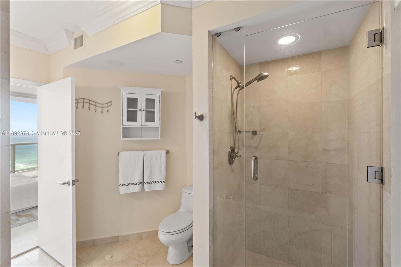 6365 Collins Avenue, Unit 3611 Miami Beach, FL 33141 - Photo 16 of 20 a bathroom with a shower toilet and sink
