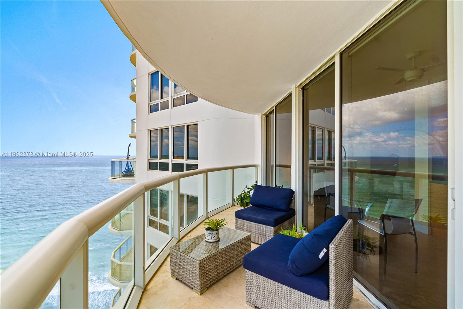 6365 Collins Avenue, Unit 3611 Miami Beach, FL 33141 - Photo 17 of 20 a balcony with couch and wooden floor