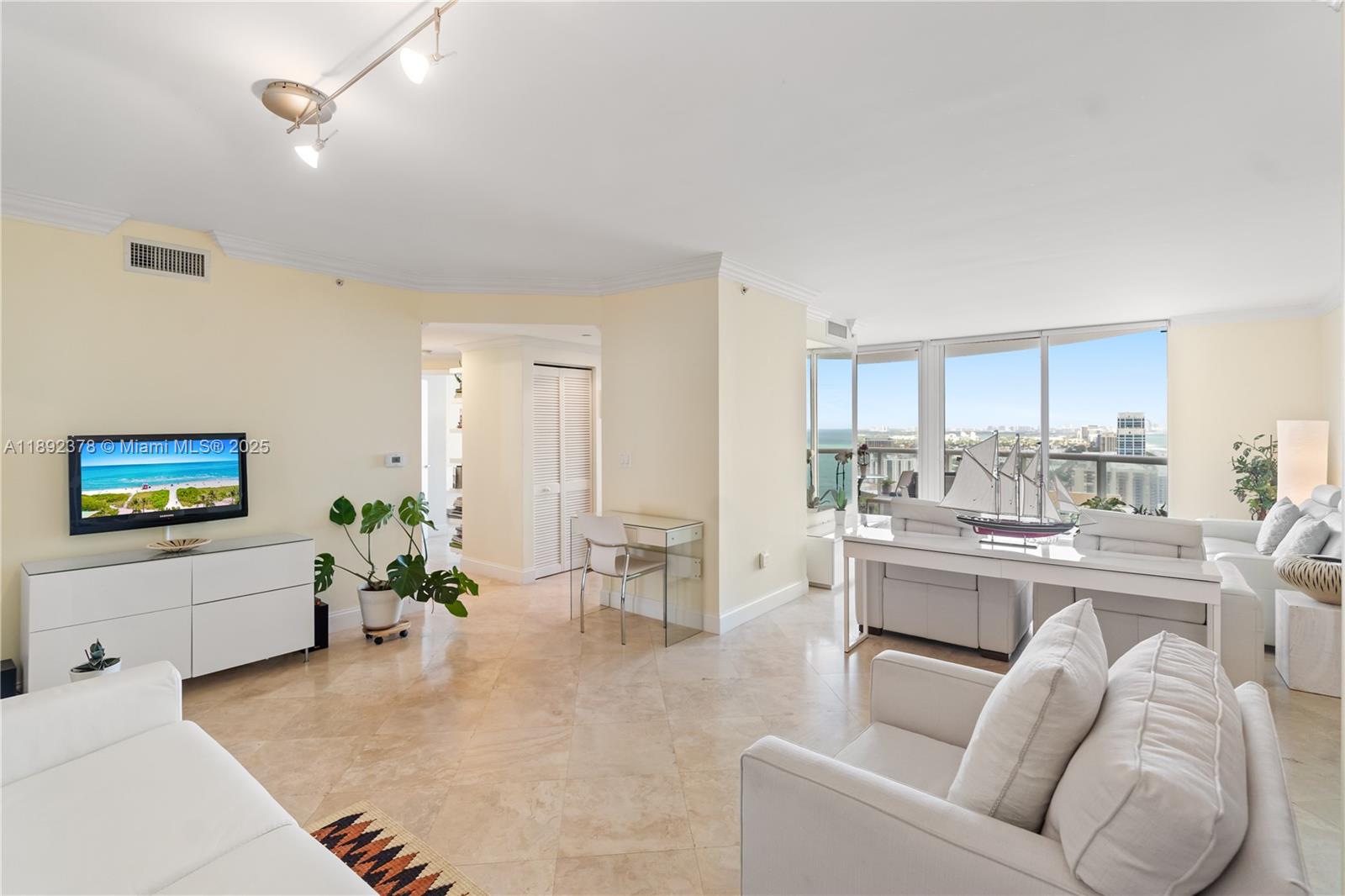 6365 Collins Avenue, Unit 3611 Miami Beach, FL 33141 - Photo 4 of 20 a living room with furniture and a flat screen tv