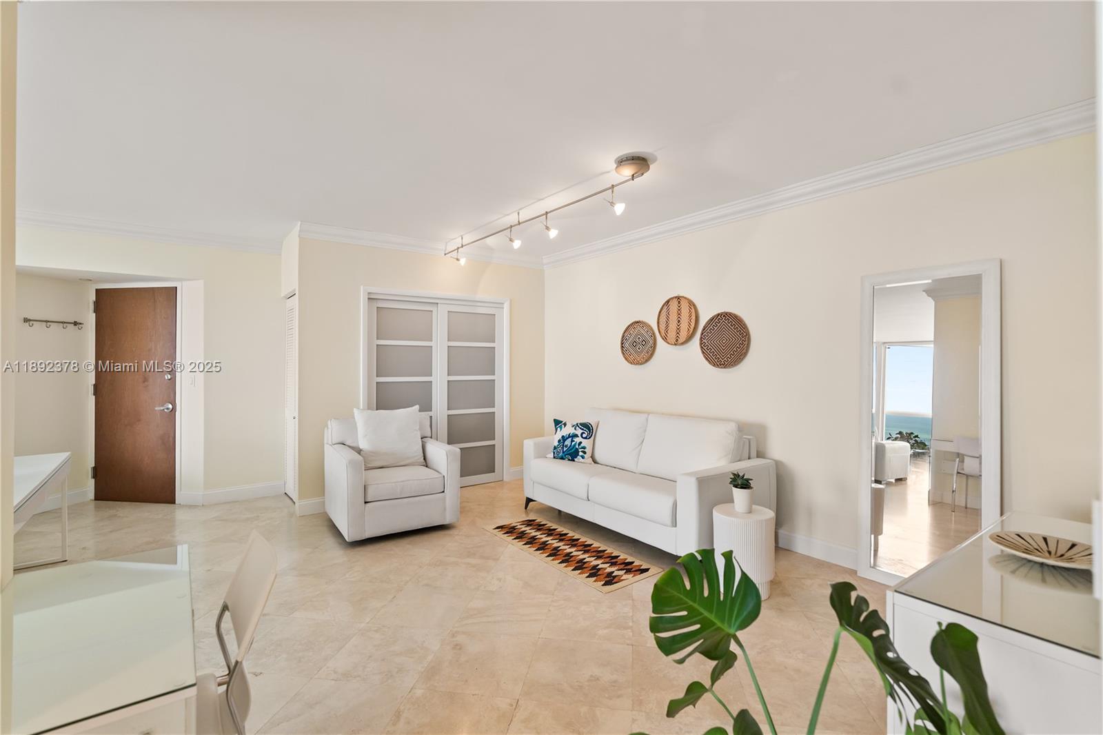 6365 Collins Avenue, Unit 3611 Miami Beach, FL 33141 - Photo 6 of 20 a living room with furniture and a large window