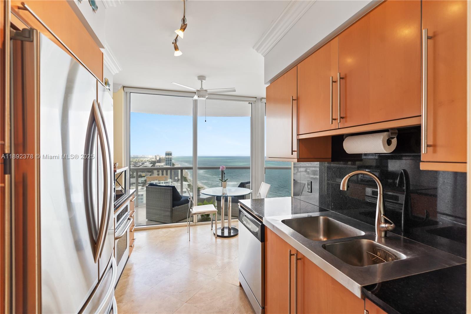 6365 Collins Avenue, Unit 3611 Miami Beach, FL 33141 - Photo 8 of 20 a kitchen with a sink appliances and cabinets