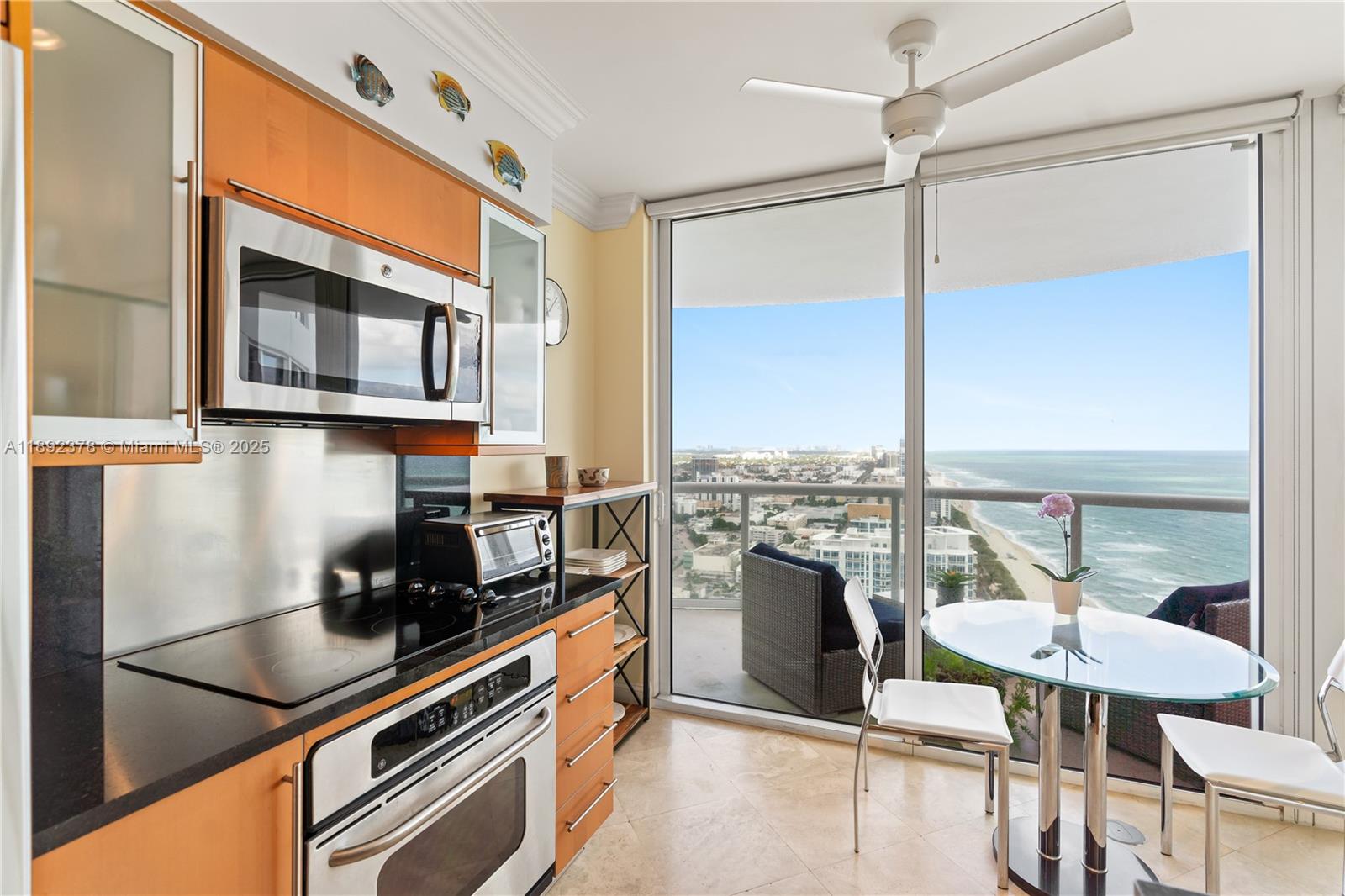 6365 Collins Avenue, Unit 3611 Miami Beach, FL 33141 - Photo 9 of 20 a kitchen with stainless steel appliances granite countertop a stove a sink and a refrigerator
