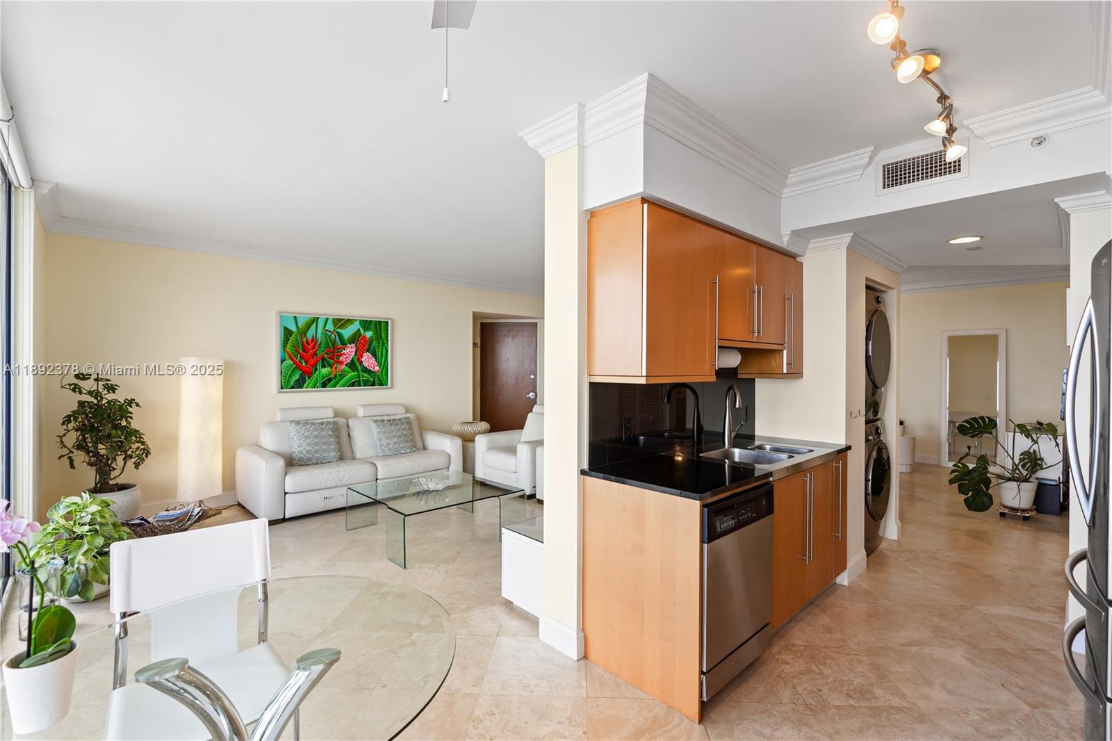 6365 Collins Avenue, Unit 3611 Miami Beach, FL 33141 - Photo 10 of 20 a living room with furniture a flat screen tv and a dining table