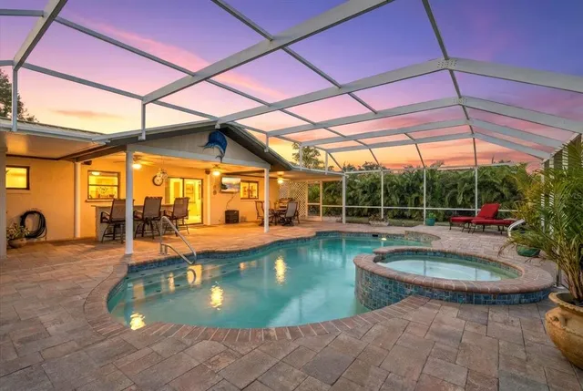 a view of a house with backyard and sitting area