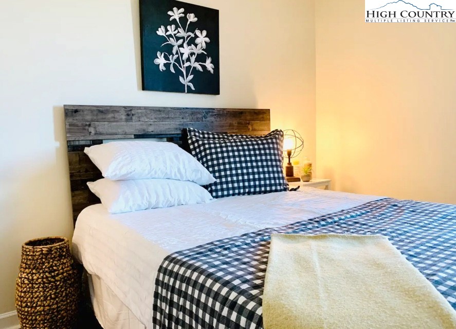 301 Pinnacle Inn Road, Unit 4315 Beech Mountain, NC 28604 - Photo 12 of 33 a bedroom with a bed and wooden floor
