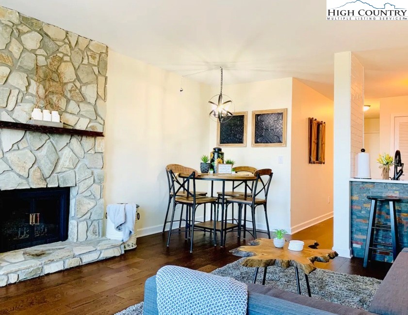301 Pinnacle Inn Road, Unit 4315 Beech Mountain, NC 28604 - Photo 6 of 33 a dining room with furniture wooden floor and a fireplace