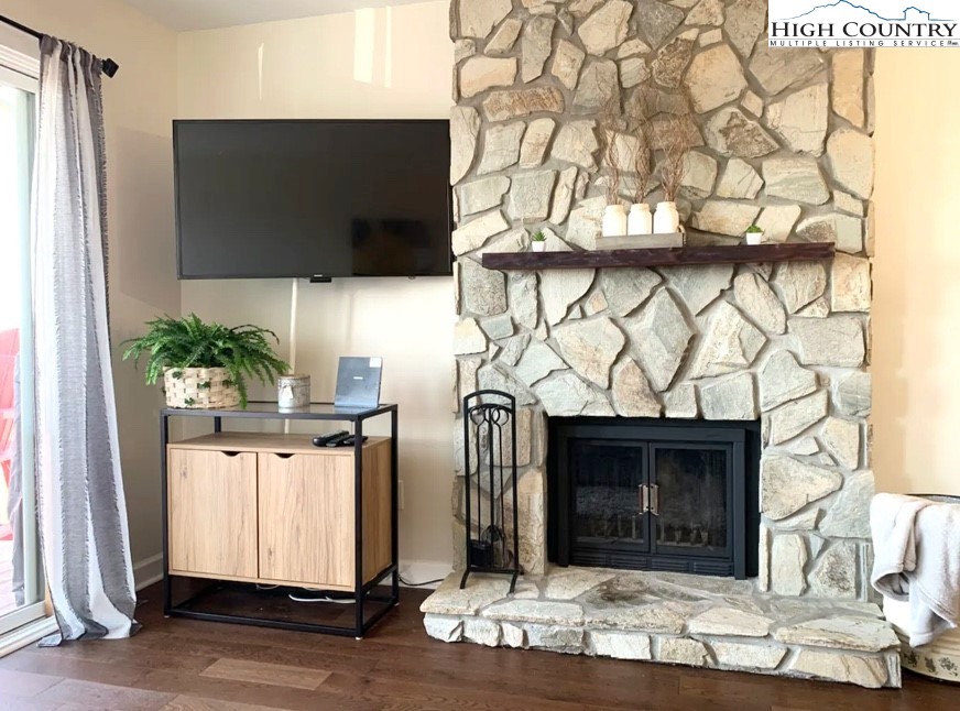 301 Pinnacle Inn Road, Unit 4315 Beech Mountain, NC 28604 - Photo 9 of 33 a living room with a fireplace and a flat screen tv