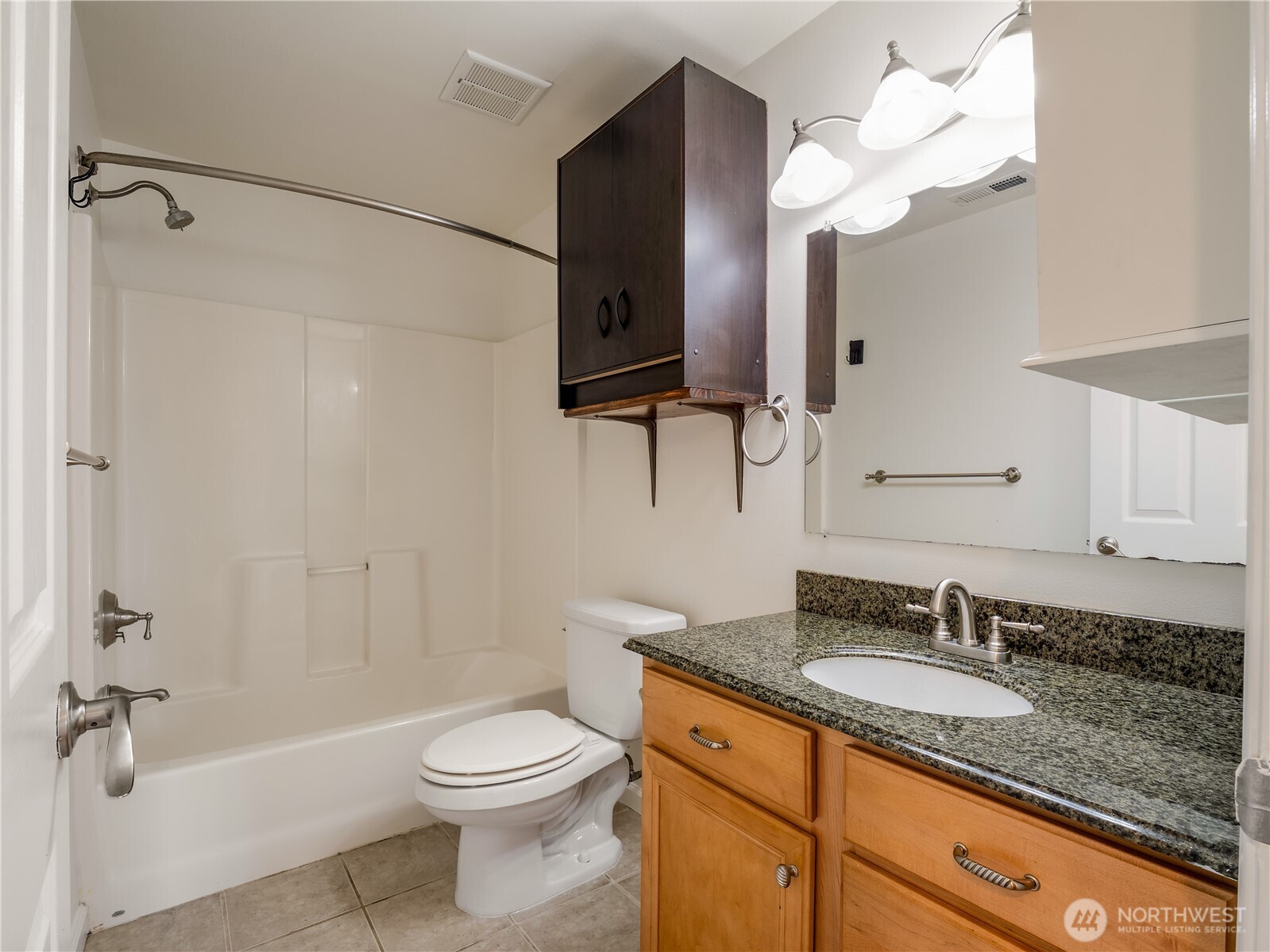 247 South D Street Buckley, WA 98321 - Photo 12 of 28 a bathroom with a granite countertop sink a toilet and a mirror