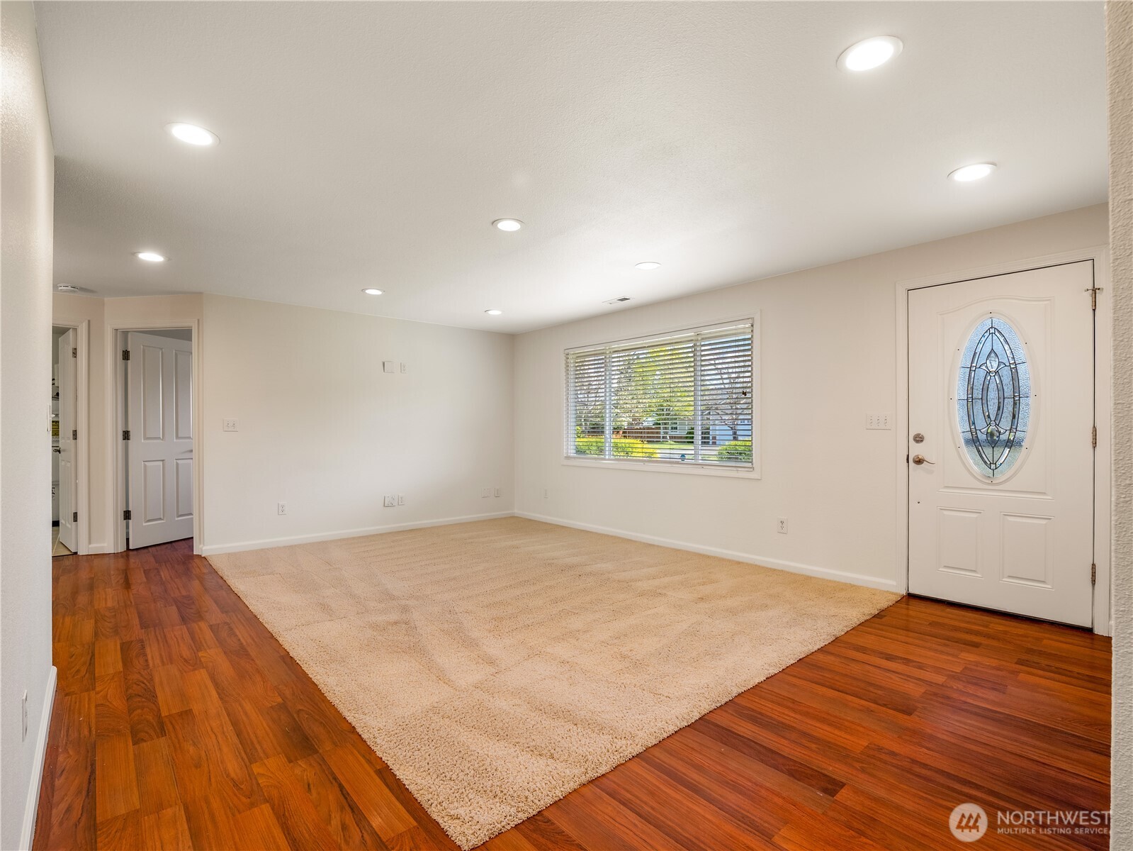 247 South D Street Buckley, WA 98321 - Photo 4 of 28 a view of an empty room with wooden floor and window