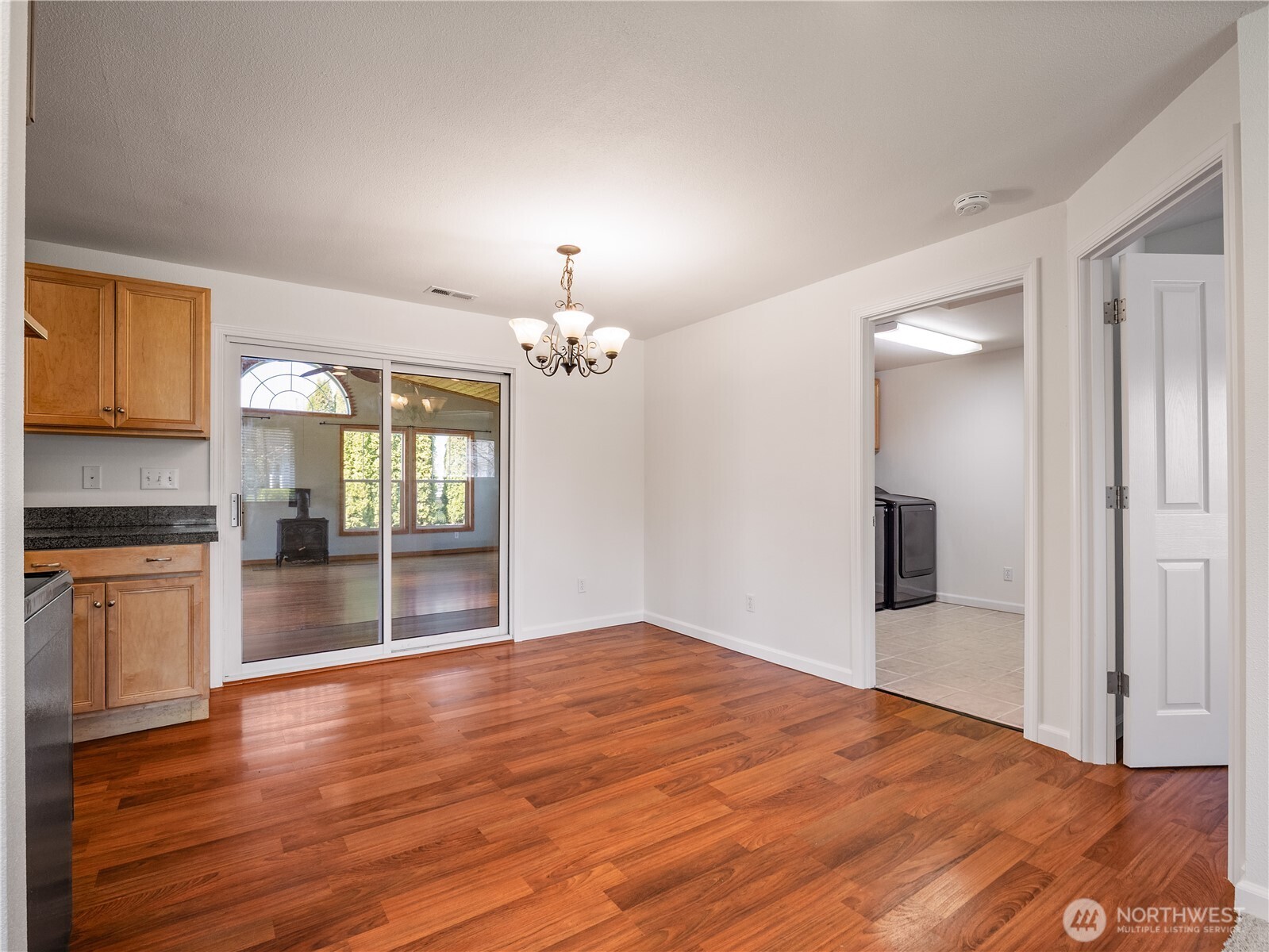 247 South D Street Buckley, WA 98321 - Photo 6 of 28 a view of empty room with wooden floor and kitchen