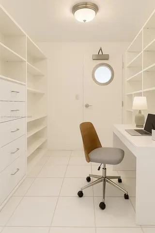 a kitchen with a sink window and stainless steel appliances