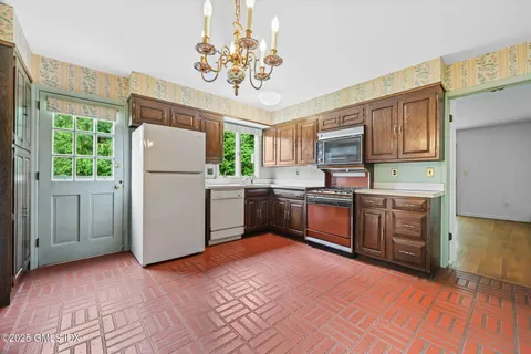 a kitchen with a refrigerator sink and cabinets