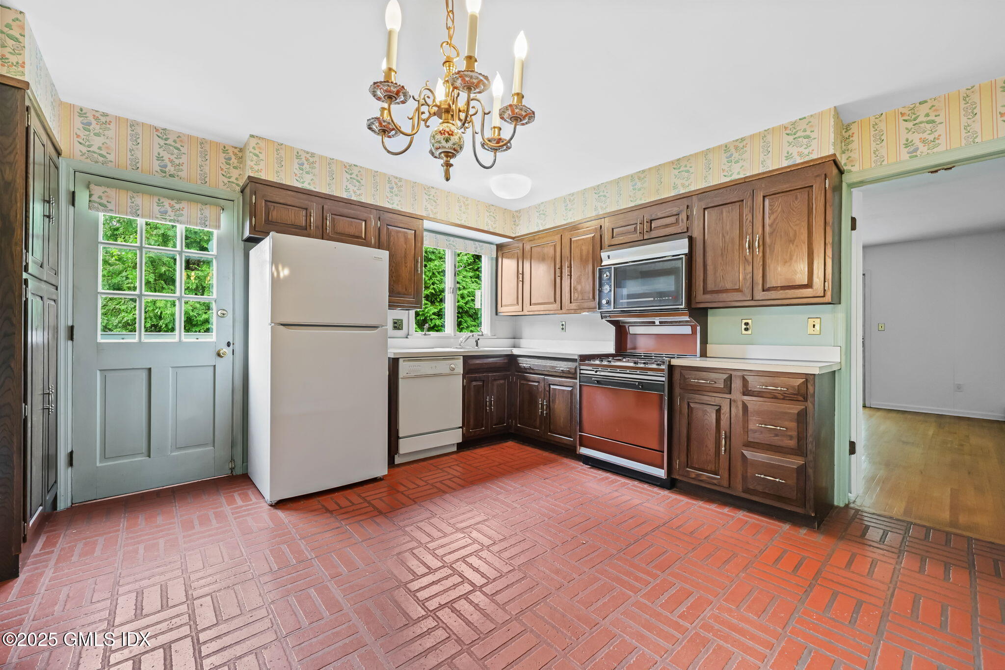 137 Shore Road Old Greenwich, CT 06870 - Photo 5 of 15 a kitchen with a refrigerator sink and cabinets