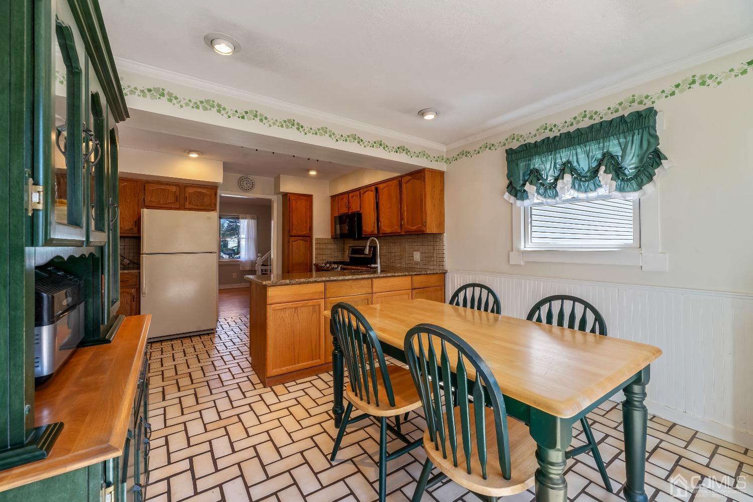 2 Perry Road East Brunswick, NJ 08816 - Photo 11 of 32 a kitchen with stainless steel appliances granite countertop a dining table chairs cabinets a sink and a window