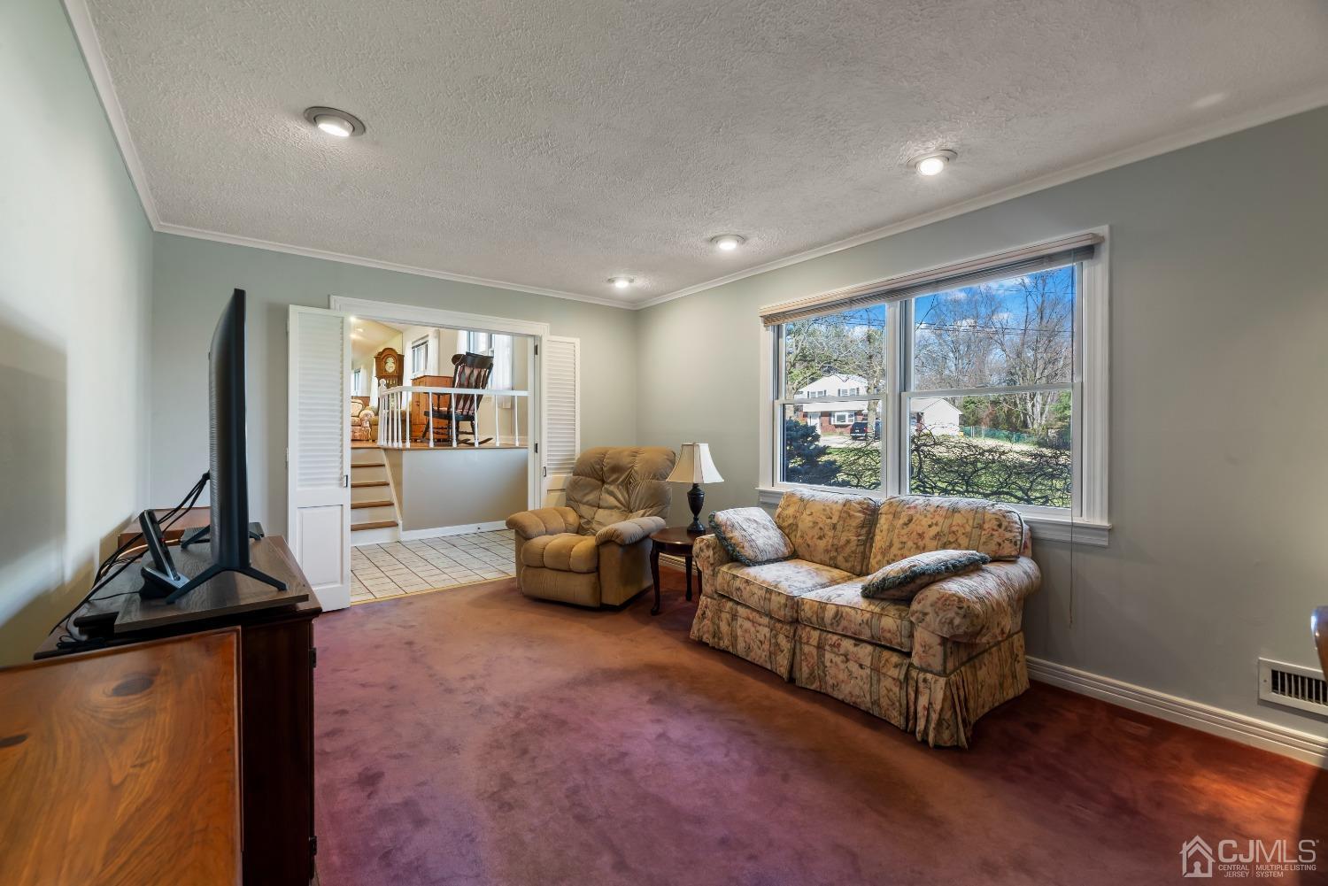 2 Perry Road East Brunswick, NJ 08816 - Photo 15 of 32 a living room with furniture and a flat screen tv