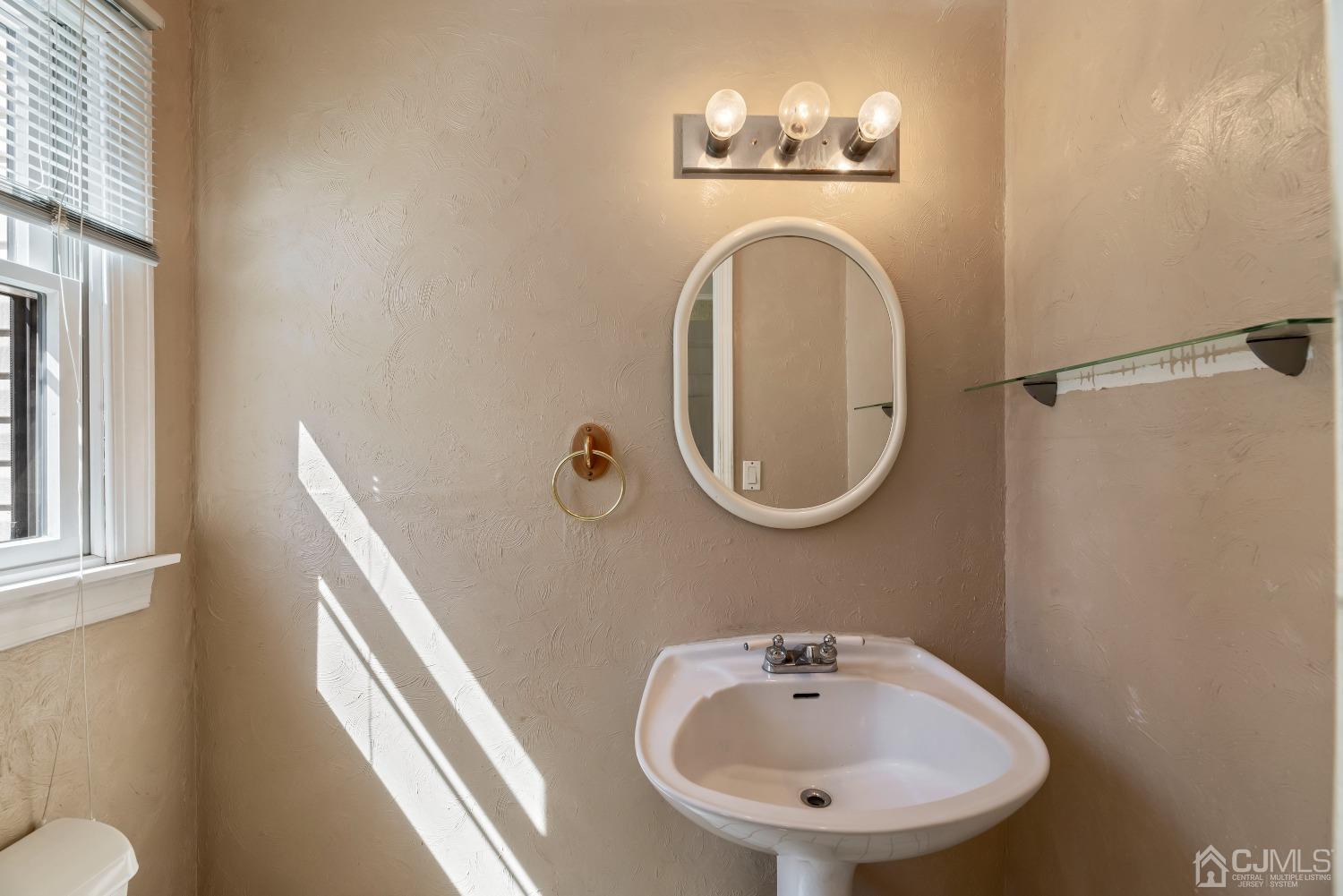 2 Perry Road East Brunswick, NJ 08816 - Photo 18 of 32 a bathroom with a sink and a mirror