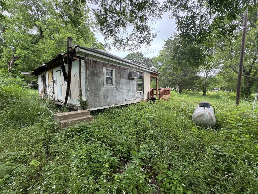 1515 Pilot Grove Road Whitewright, TX 75491 - Photo 12 of 13 a backyard of a house with table and chairs