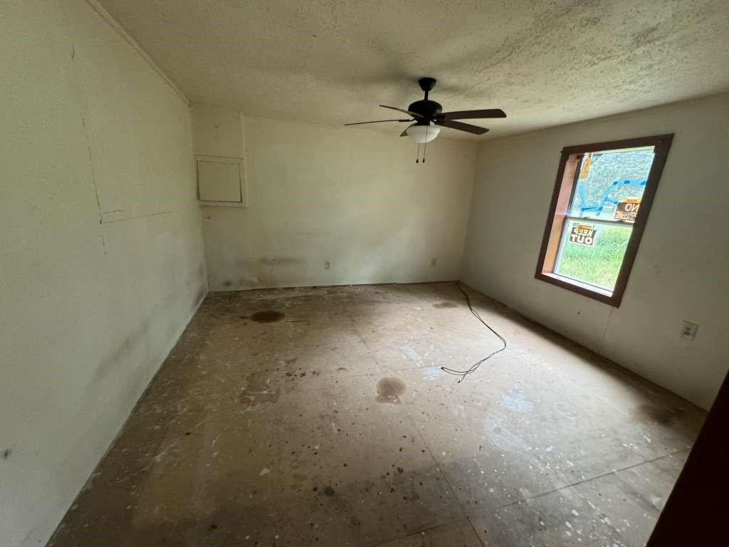 1515 Pilot Grove Road Whitewright, TX 75491 - Photo 6 of 13 an empty room with a empty space and windows