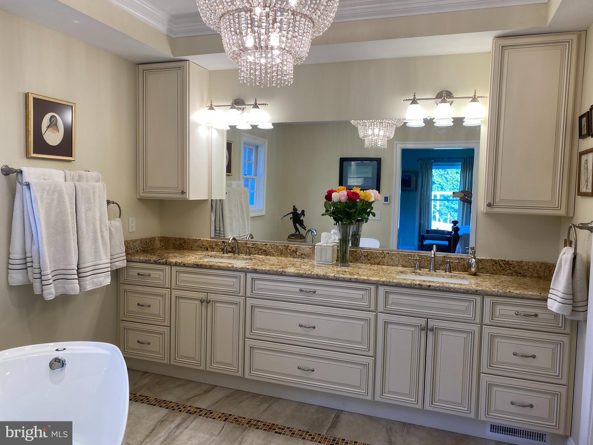 970 St George Barber Road Davidsonville, MD 21035 - Photo 18 of 69 a spacious bathroom with a granite countertop sink a large mirror and a shower