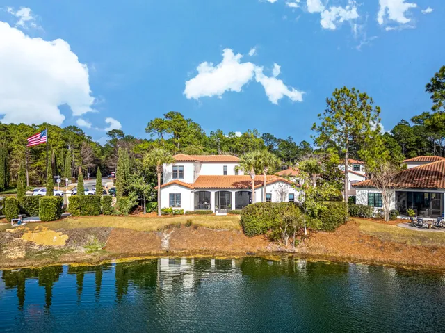 a view of a lake with a house swimming pool and outdoor space