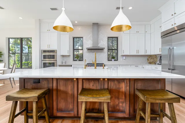 a kitchen with cabinets and chairs