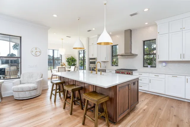 a kitchen with a sink a stove a dining table and chairs