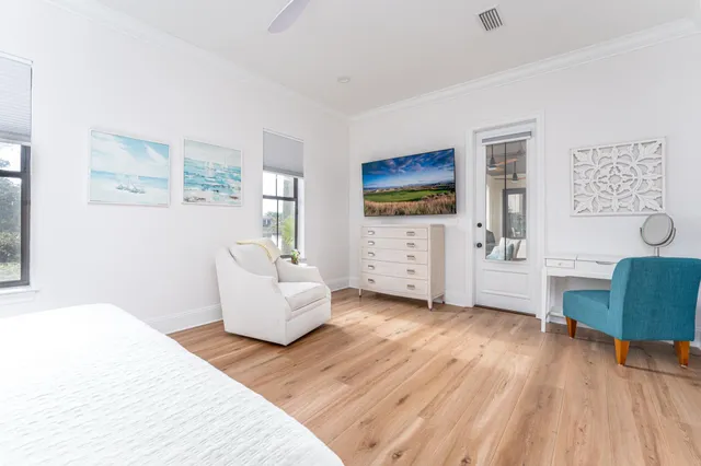 a bedroom with furniture and a wooden floor