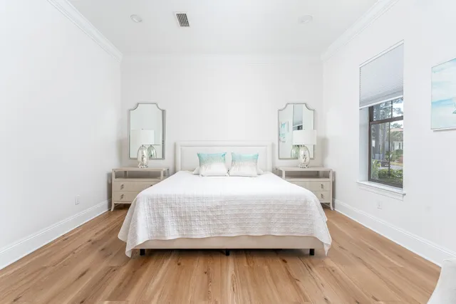 a bedroom with a bed and wooden floor