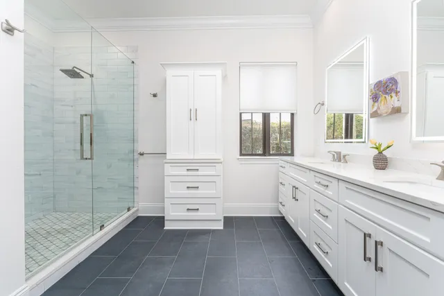 a spacious bathroom with a granite countertop sink a mirror a shower and a bathtub