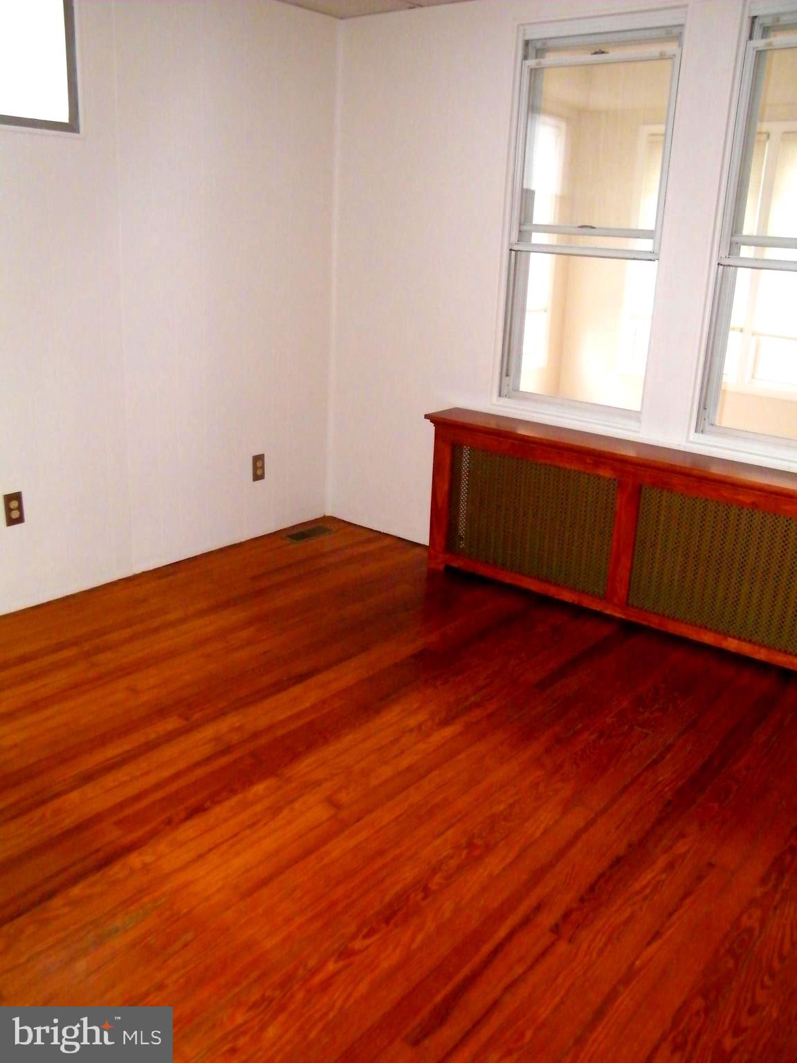 7602 Old Harford Road Parkville, MD 21234 - Photo 11 of 48 a view of empty room with wooden floor and fan