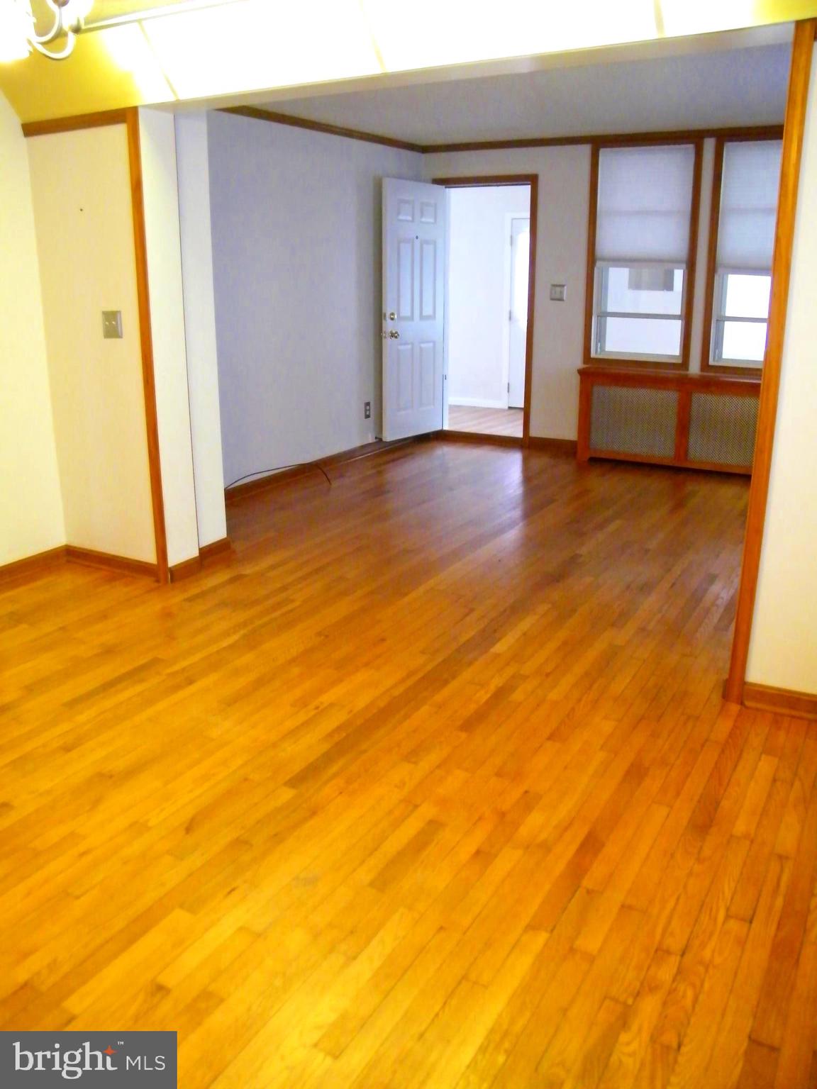 7602 Old Harford Road Parkville, MD 21234 - Photo 12 of 48 a view of an empty room with window and wooden floor