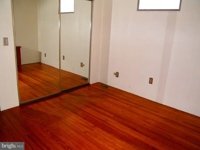 a view of room with wooden floor