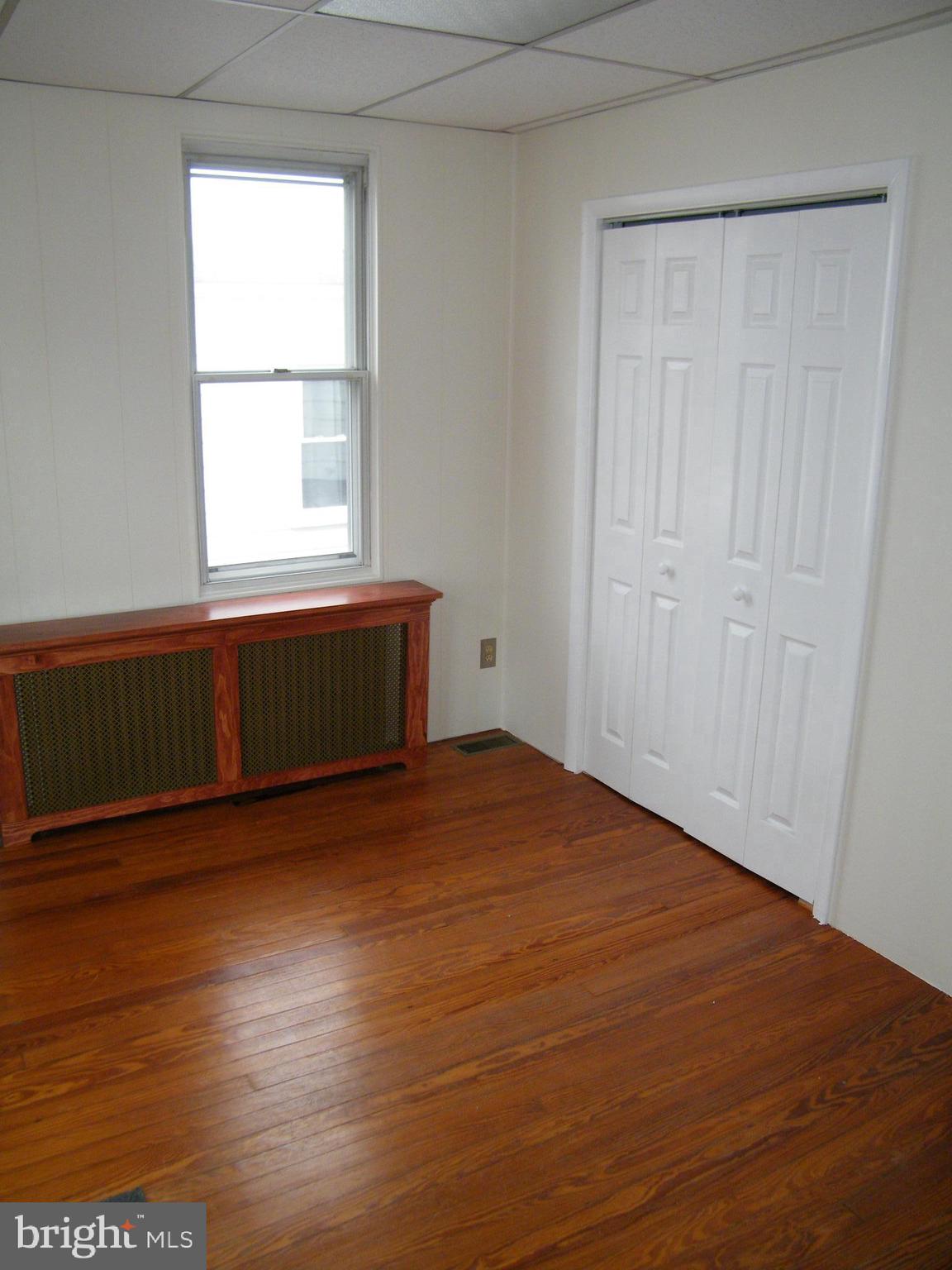 7602 Old Harford Road Parkville, MD 21234 - Photo 20 of 48 an empty room with wooden floor and windows